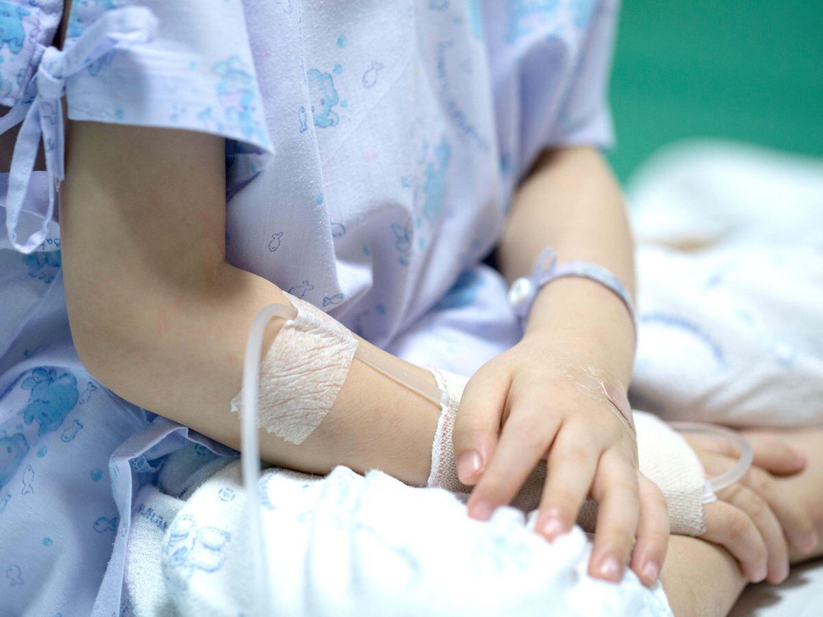 Sick child receiving a saline solution in hospital