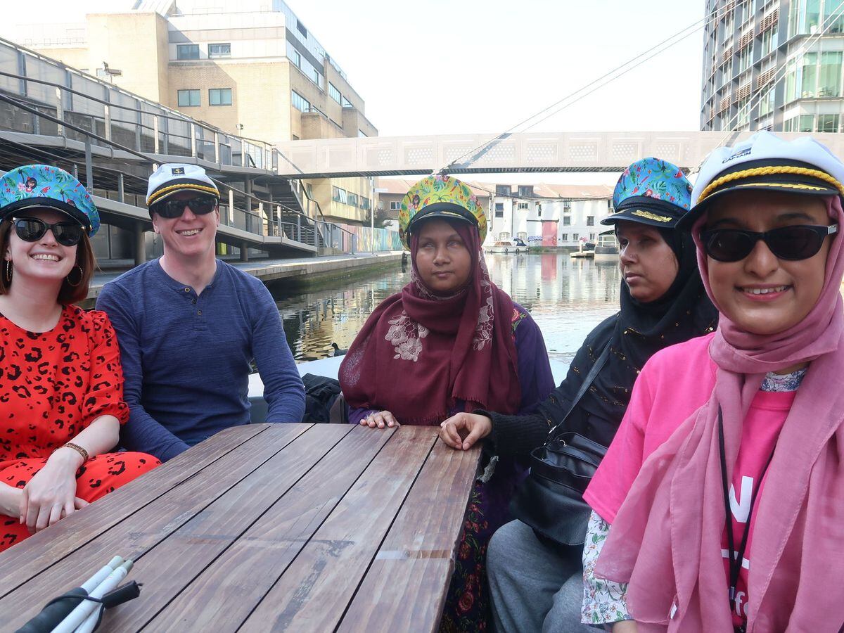 Nanjiba Misbah, centre, and other members of the RNIB on a boat trip