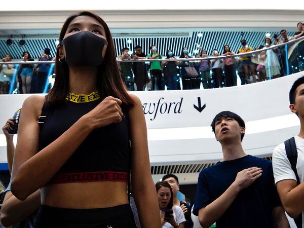 Demonstrators sing Glory To Hong Kong at the Times Square shopping centre in Hong Kong in 2019