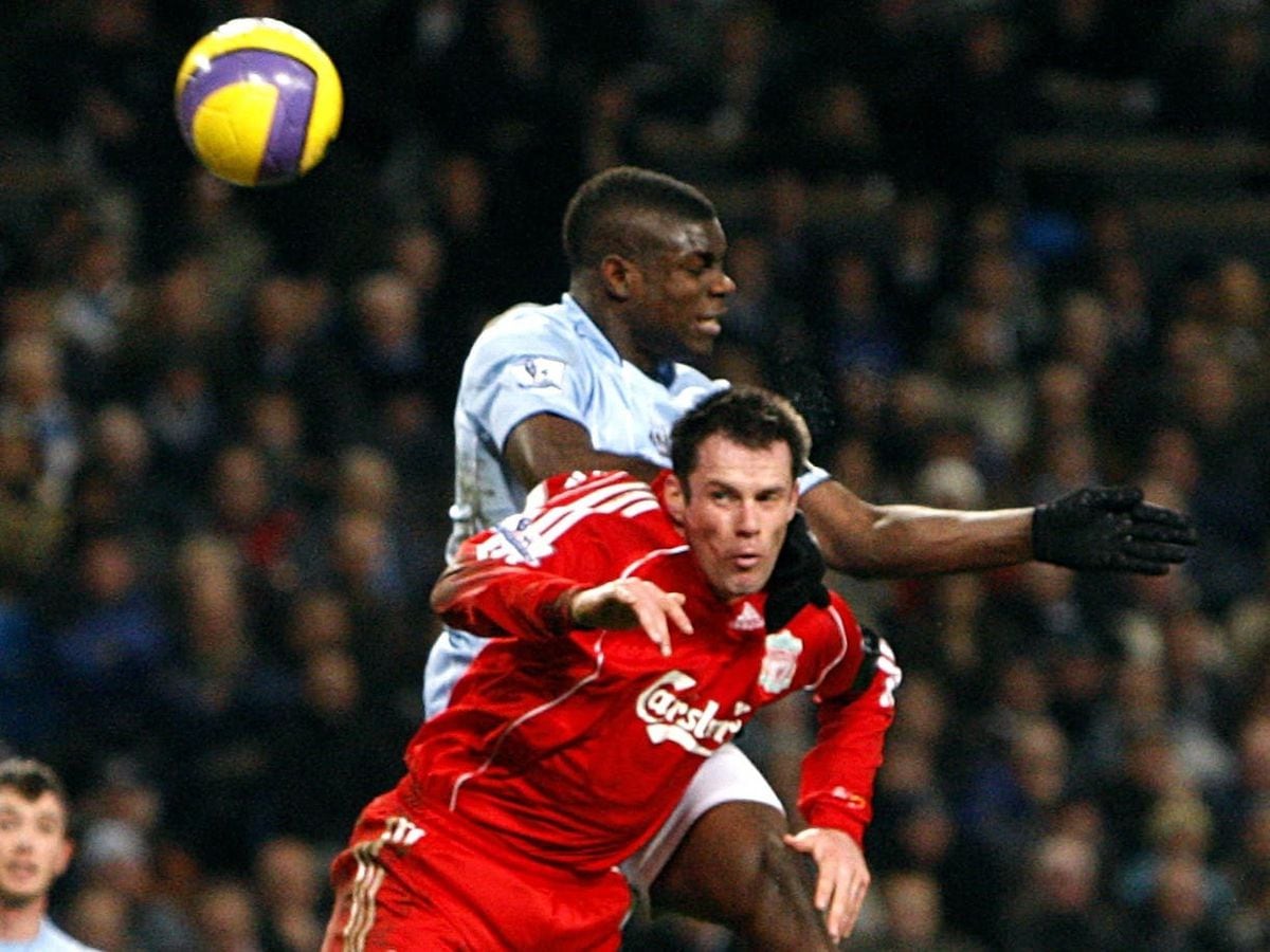 Manchester City‘s Micah Richards and Liverpool’s Jamie Carragher battle for the ball