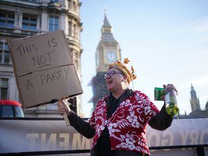 A protestor in Parliament Square demonstrating against Downing St parties