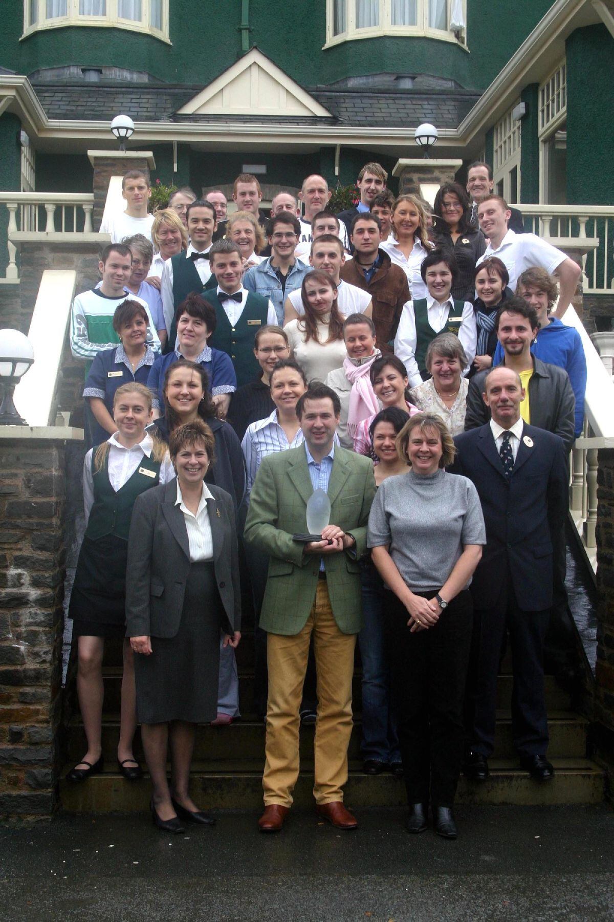 Justin Baird-Murray, managing director of The Metropole Hotel, Llandrindod Wells, celebrates the Business Tourism Award with members of staff in 2005
