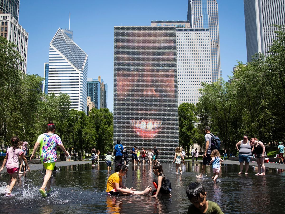 Children play in a fountain in Chicago as temperatures soared