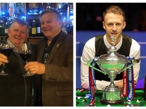 Happy punter Neil Morrice (left) celebrates with a friend after Judd Trump (right) became world champion