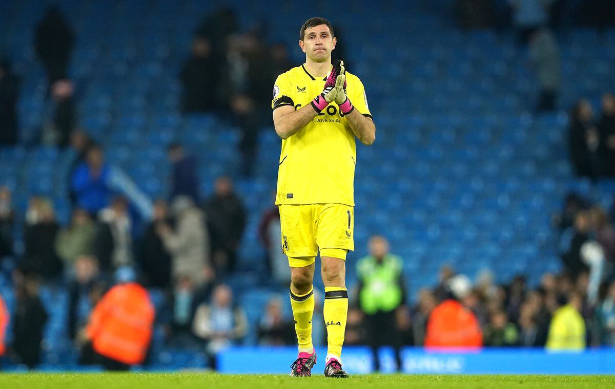 Aston Villa goalkeeper Emiliano Martinez applauds .