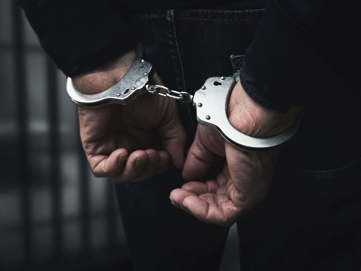 Arrested man with cuffed hands