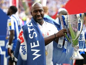 Sheffield Wednesday manager Darren Moore celebrates with the trophy and promotion to the Sky Bet Championship following victory in the Sky Bet League One play-off final at Wembley 