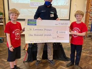Severn Trent's Chris Harper hands over a cheque to St Lawrence Primary School pupils and twins Toby and Jacob Cleaton