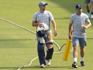 England's captain Jos Buttler, right, walks with teammate Will Jacks