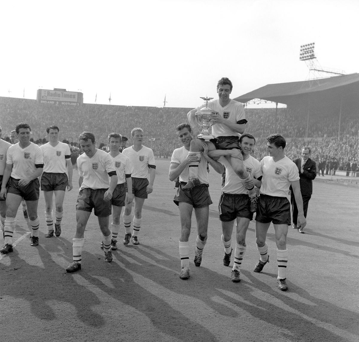 England's victorious players carry their captain aloft with the Championship Trophy. (l-r) Bobby Smith, Bobby Robson, Jimmy Greaves, Bryan Douglas, Ron Flowers, Peter Swan, captain Johnny Haynes (with trophy), Jimmy Armfield and Mike McNeil.