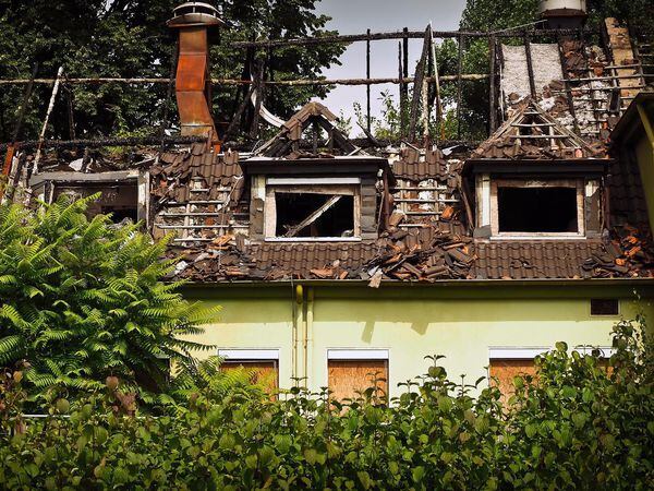 Who pays? (stock image of a fire-damaged house) 
