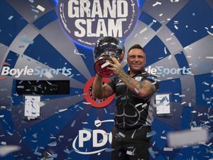 Gerwyn Price celebrates retaining his Grand Slam of Darts title (Picture: Lawrence Lustig)