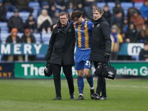 Tom Bayliss of Shrewsbury Town leaves the pitch with an injury.