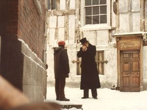 Not in the script... Film star George C. Scott lights up a cigarette during the filming of A Christmas Carol in Shrewsbury in 1984. Picture: Anne Roberts.
