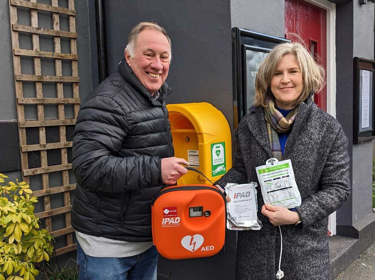 John Ingham, chair of the Belle Vue & Coleham Community Action Group, and Councillor Kate Halliday, outside The Prince of Wales pub in Shrewsbury with the new defibrillator