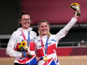 Katie Archibald, left, and Laura Kenny of Team Britain celebrate during a medal ceremony for the track cycling women's madison race at the 2020 Summer Olympics