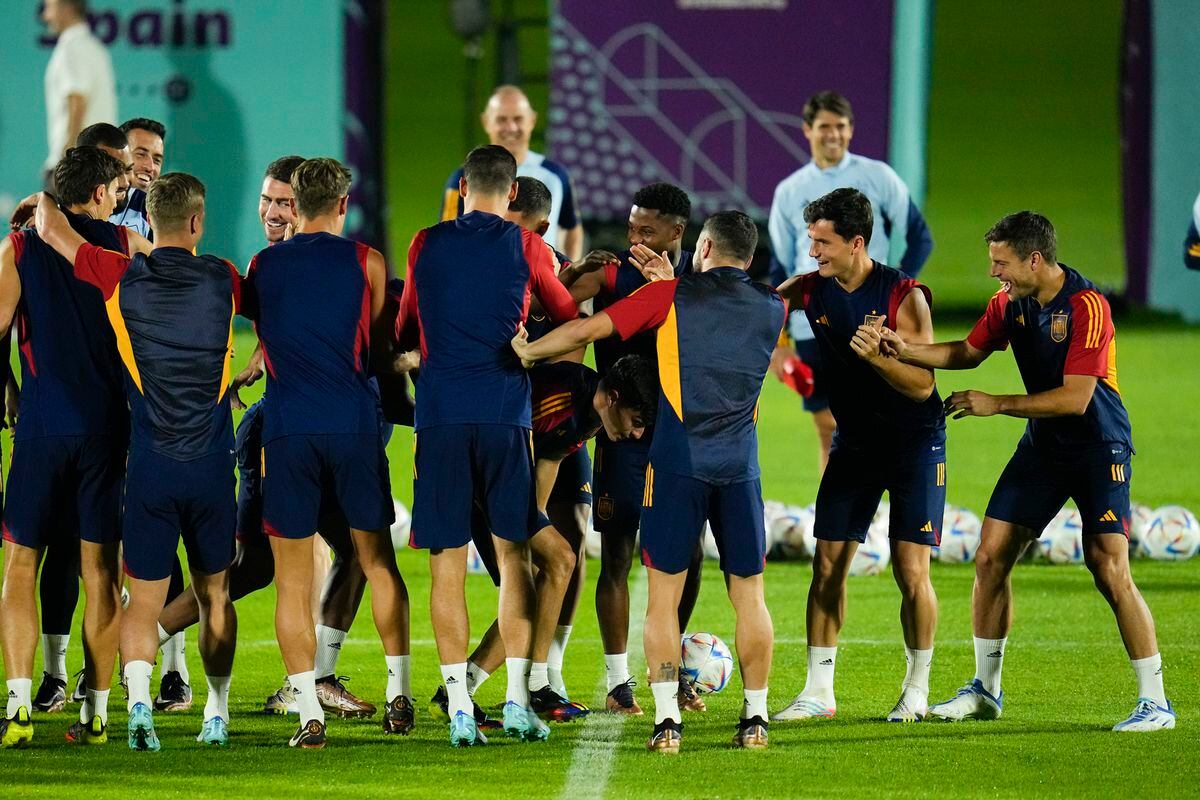Spain players make a tunnel as Spain's Pedri, center, runs through it during an official training session at Qatar University, in Doha, Qatar, Saturday, Nov. 26, 2022. Spain will play its second match in Group E in the World Cup against Germany on Nov. 27. (AP Photo/Julio Cortez).