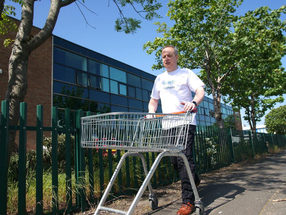 Canon Gavin Kibble MBE with a shopping trolley