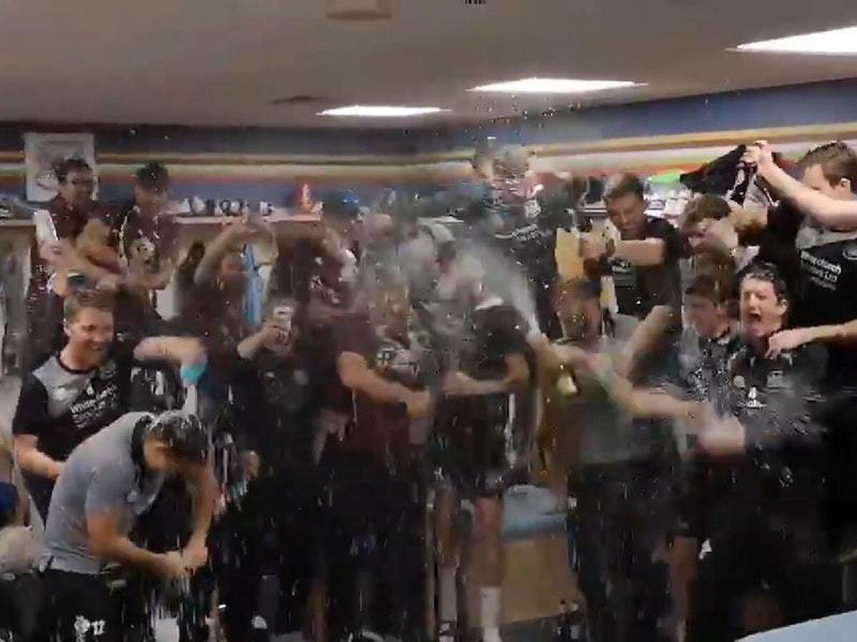 Gloucestershire and Northamptonshire players celebrate promotion together
