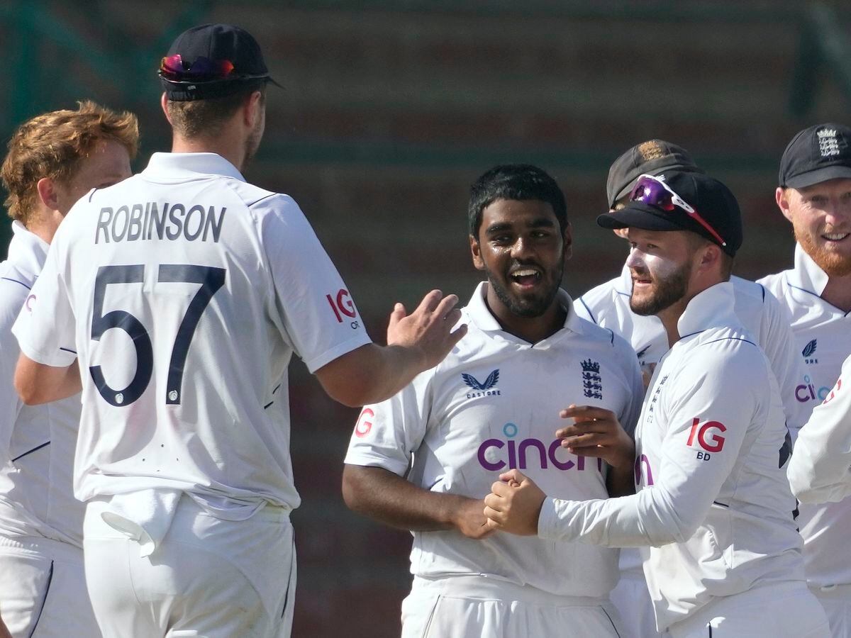 England's Rehan Ahmed, center, celebrates with teammates after taking the wicket of Pakistan's Saud Shakeel during the third day of third test cricket match between England and Pakistan, in Karachi, Pakistan, Monday, Dec. 19, 2022. (AP Photo/Fareed Khan).