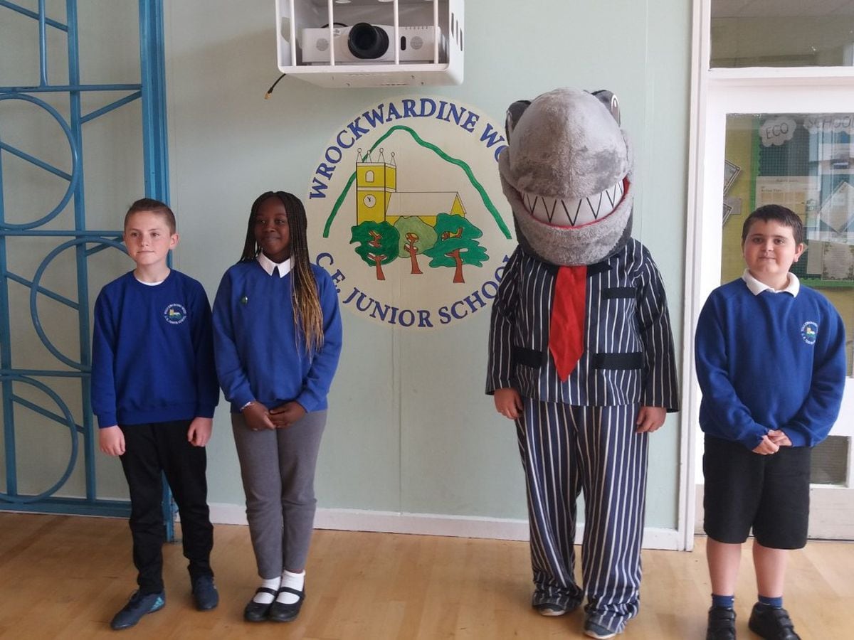 A group of children welcome the ‘Stop Loan Sharks’ mascot Sid to the school