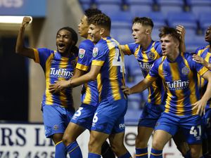 Travis Hernes of Shrewsbury Town celebrates after scoring a goal to make it 1-0 with his team mates.