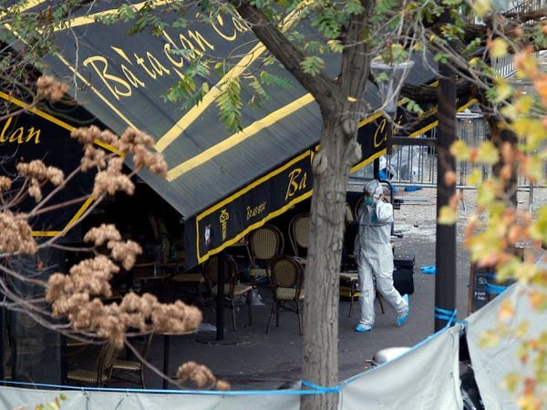 An investigator works outside the Bataclan concert hall (Christophe Ena/PA)
