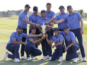 Francesco Molinari, the captain of Italy and Continental Europe team, holds the trophy with his team, after they beat the Great Britain and Ireland Team, and won the Hero Cup at Abu Dhabi Golf Club, in Abu Dhabi, United Arab Emirates, Sunday, Jan. 15, 2023. (AP Photo/Kamran Jebreili).