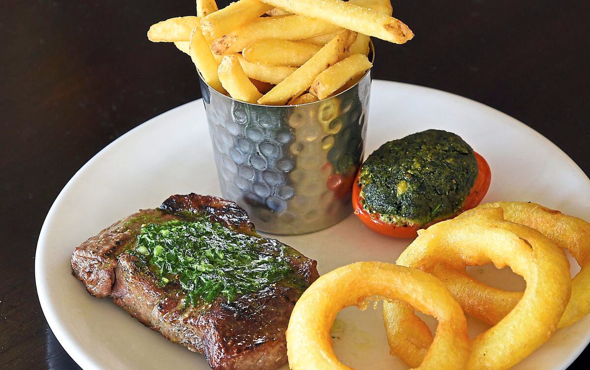 Raise the steaks – the sirloin steak with fries, onion rings and grilled tomatoPictures by Russell Davies