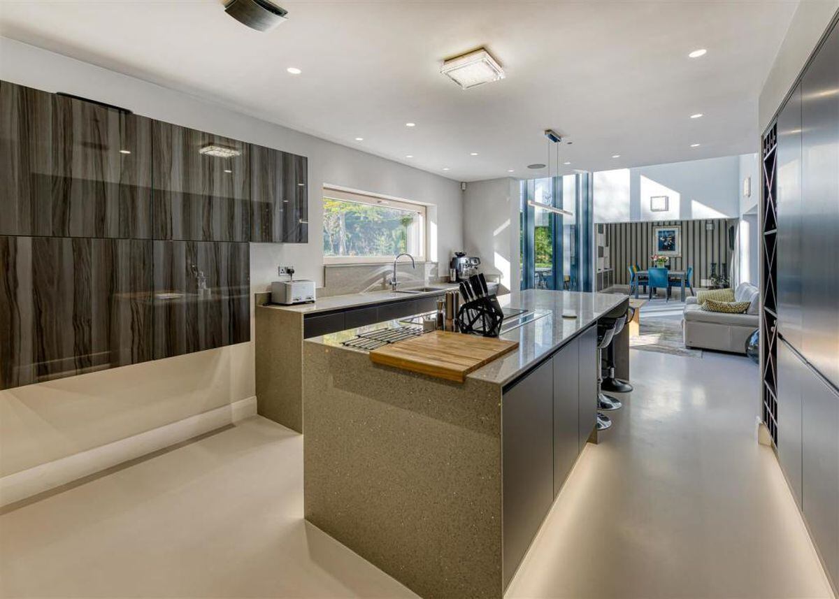The high-tech kitchen features an island and top of the range appliances. Photo: Berriman Eaton.