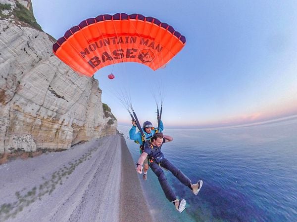 The pair in the air after jumping from the cliff. (Image: © Mountain Man BASE) 