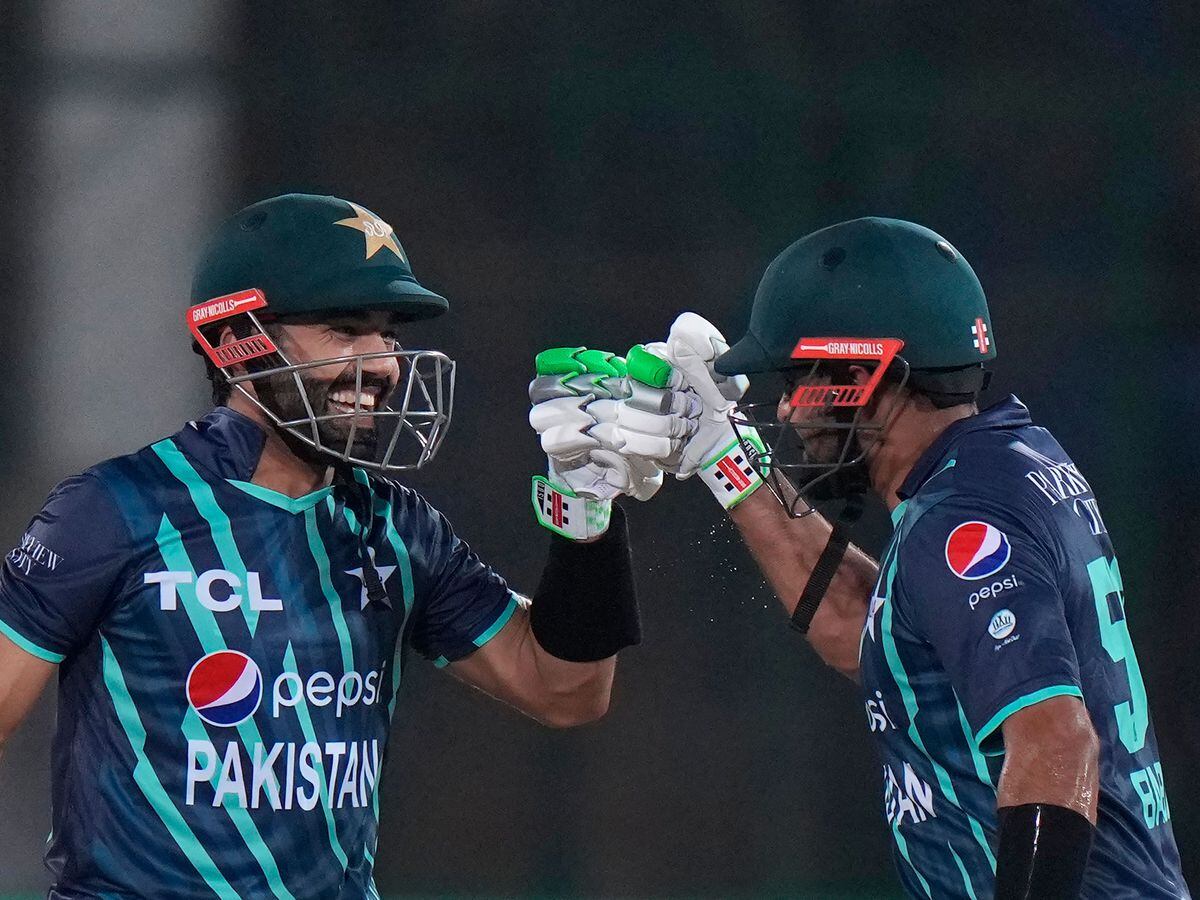 Pakistan’s Mohammad Rizwan, left, and captain Babar Azam celebrate scoring runs