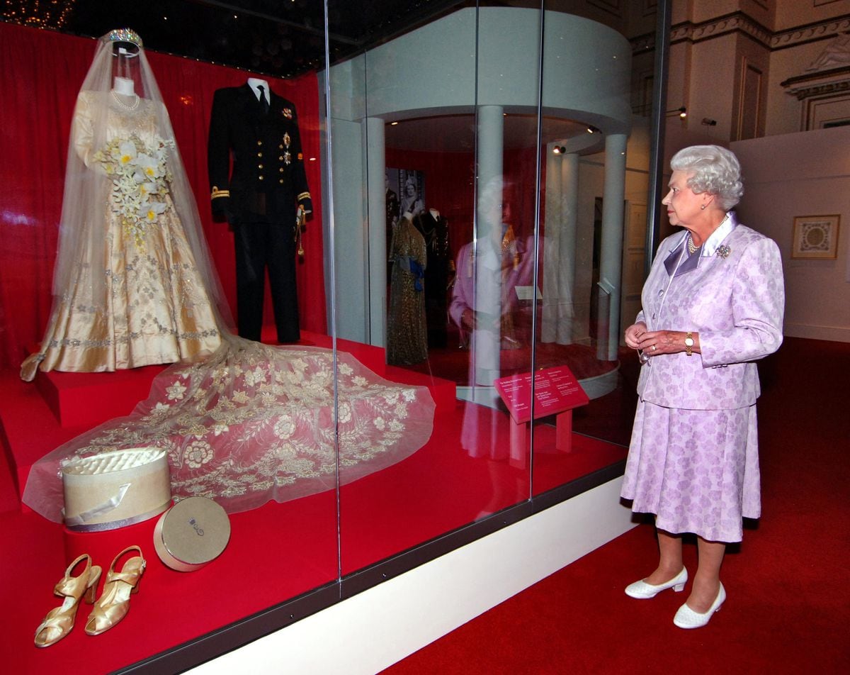 The Queen viewed poignant reminders of her wedding day as she toured an exhibition celebrating the 60th anniversary of her marriage to the Duke of Edinburgh
