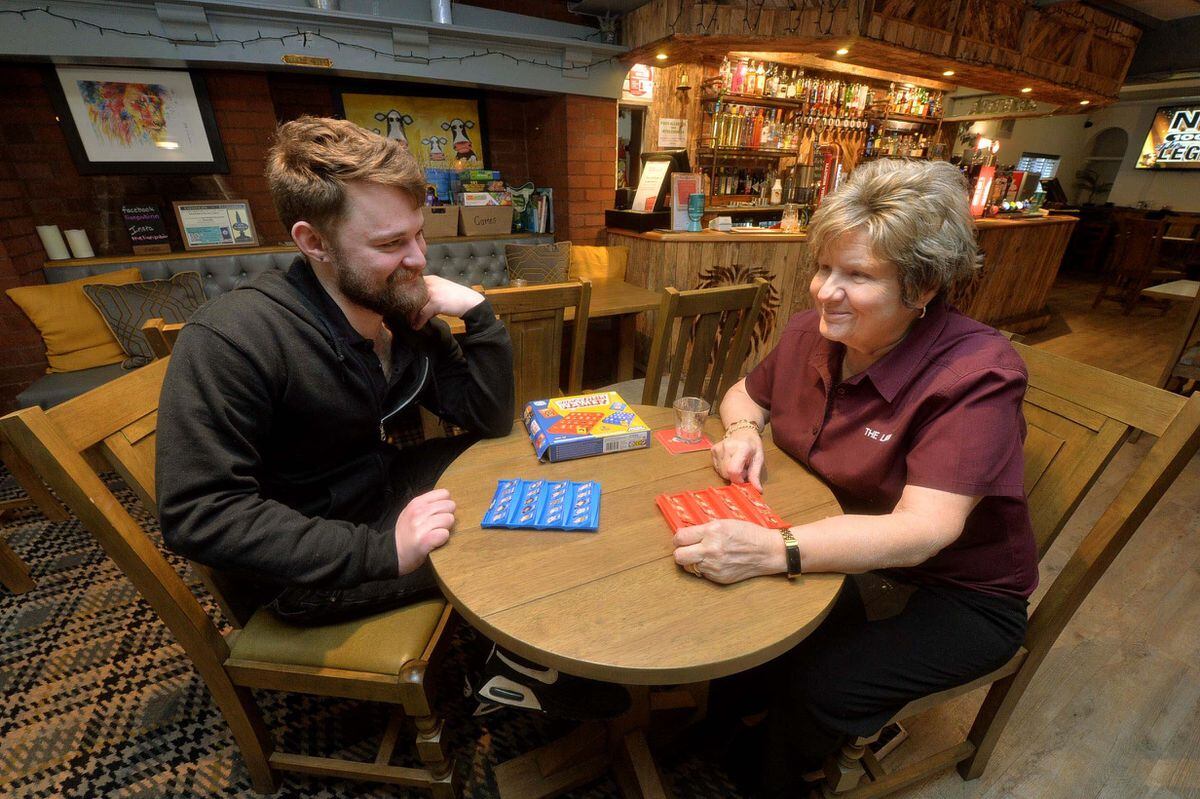 The Lion Inn Telford. Landlord: Jack Partridge, and with him is staff: Jan Hickinbottom. Jan has been involved in the pub for many many years. Playing one of the many games they have for punters to choose..