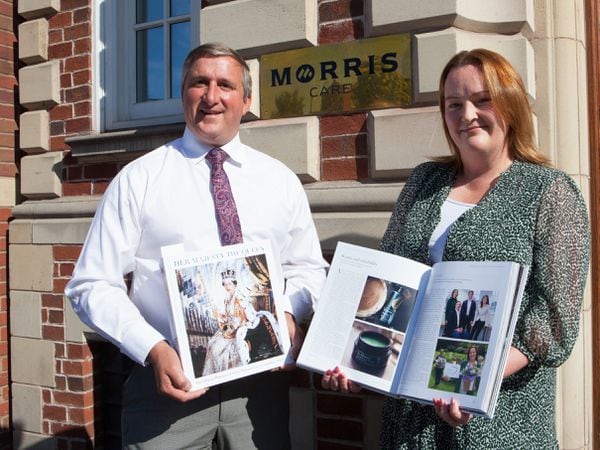 Morris and Company chairman Robin Morris and Morris Care CEO Lucy Holl with the Official Queen's Jubilee Pageant Commemorative Album