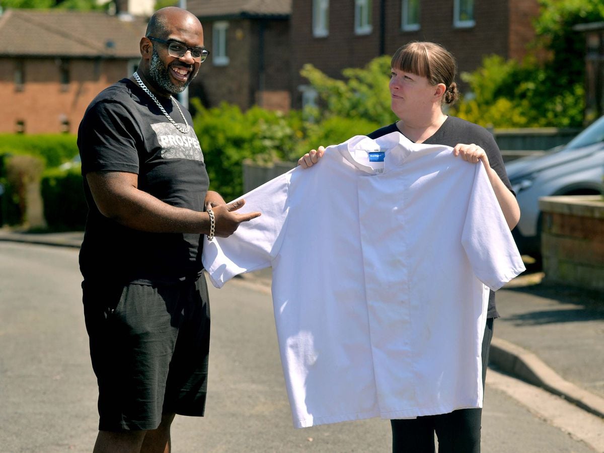 Super slimmer Andrew Campbell with his wife holding his old Chef jacket – a Four X Large.