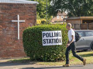 A man walks past a polling station (Danny Lawson/PA)