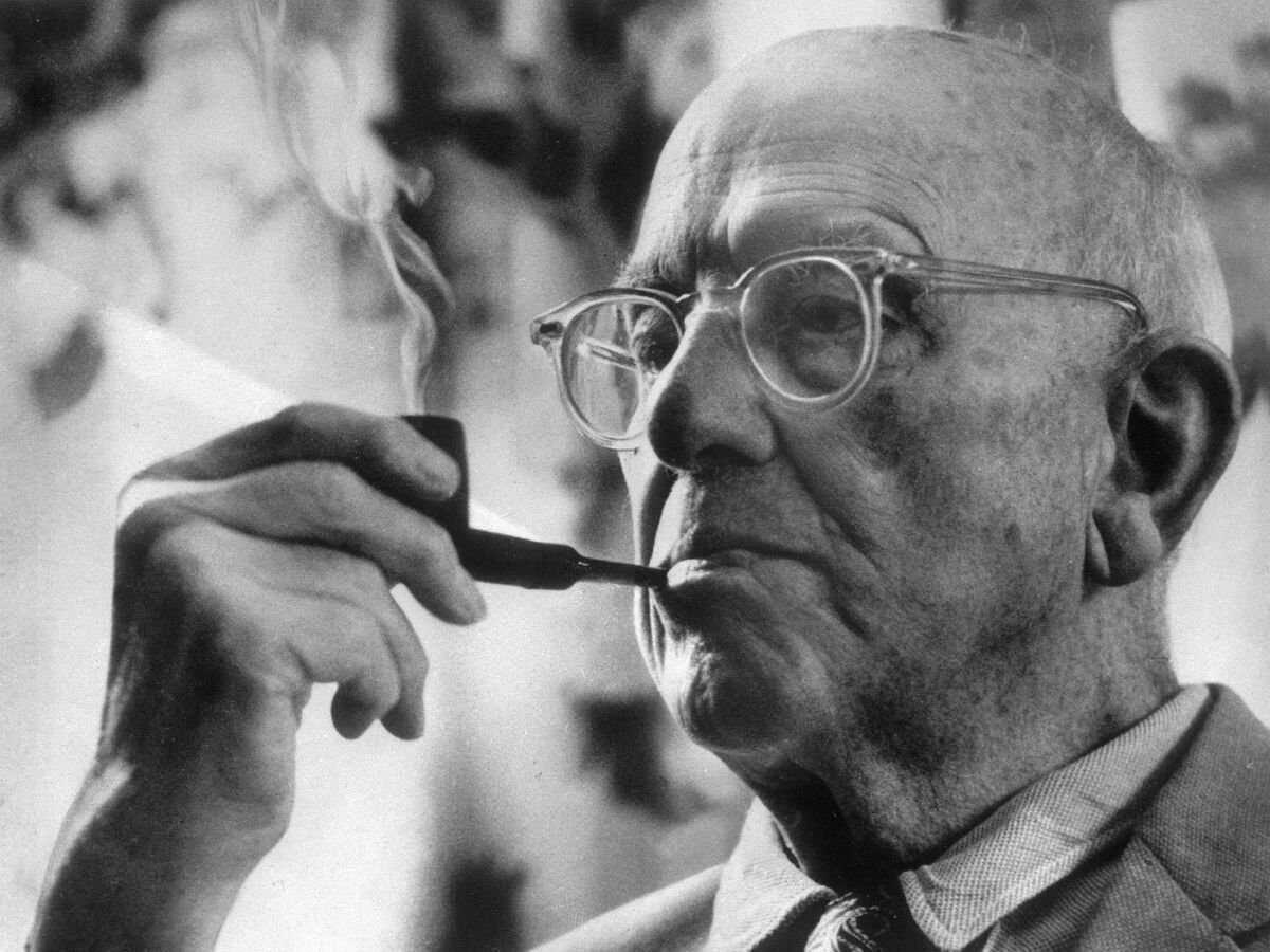 British novelist P.G.Wodehouse puffs on his pipe during an interview at his Long Island home in Remsenburg, New York