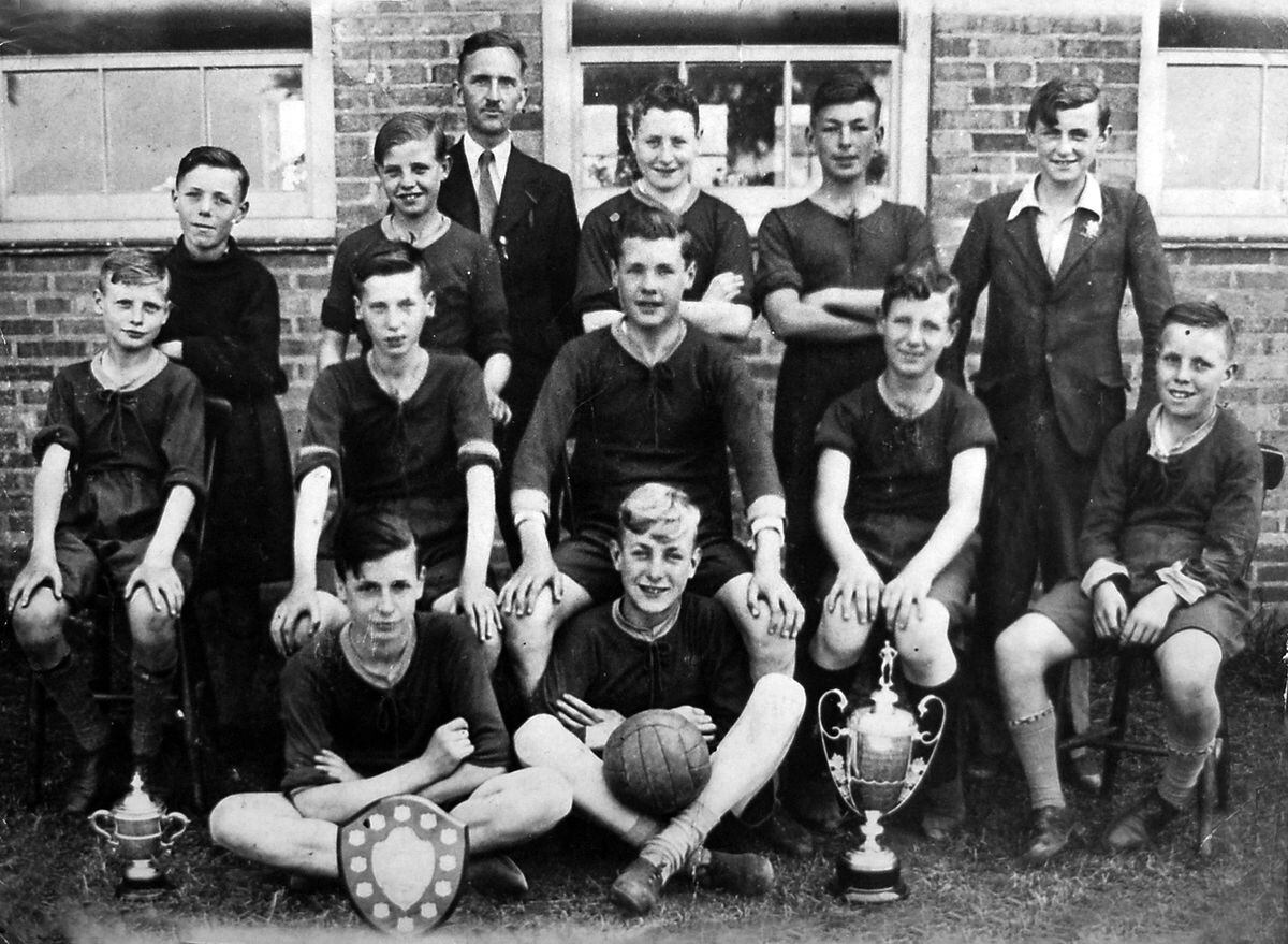 Billy holding the ball with Madeley Senior School football team in the 1937-38 season when they were unbeaten.