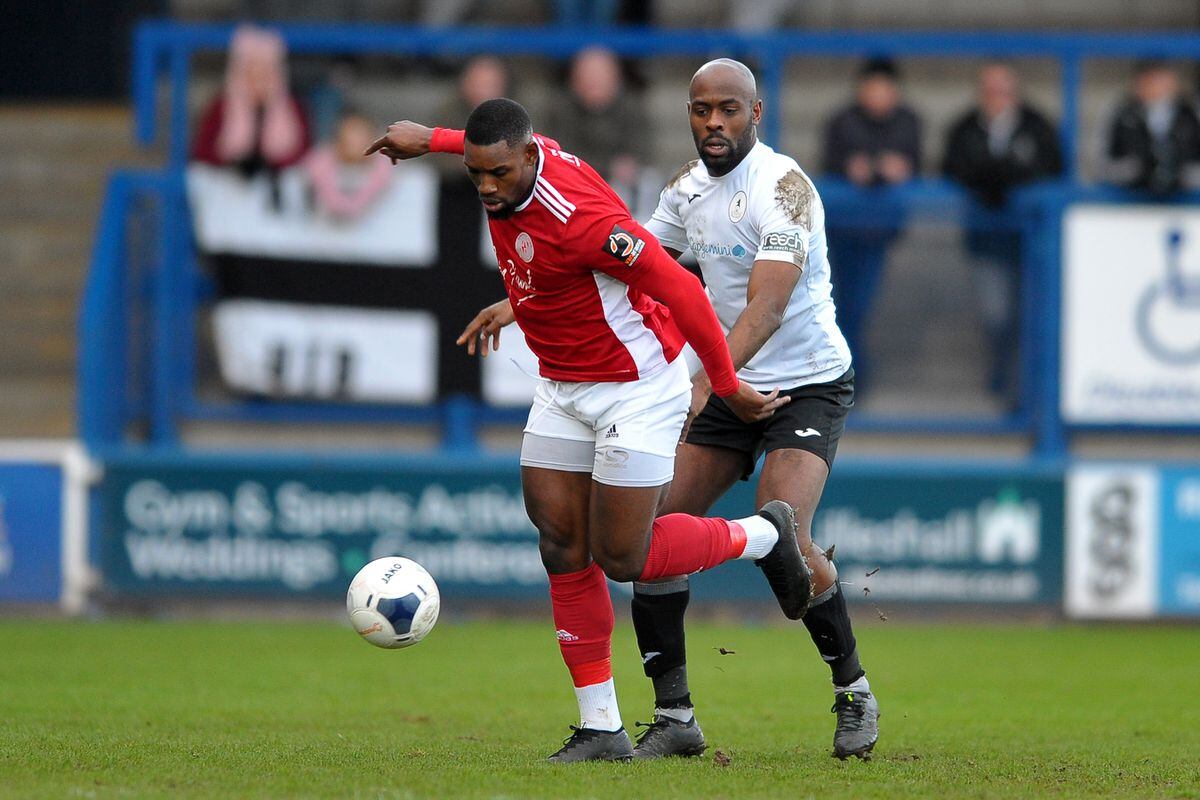 Theo Streete of Telford battles for the ball with Lee Ndlovu of Brackley (Picture credit: Mike Sheridan/Ultrapress)