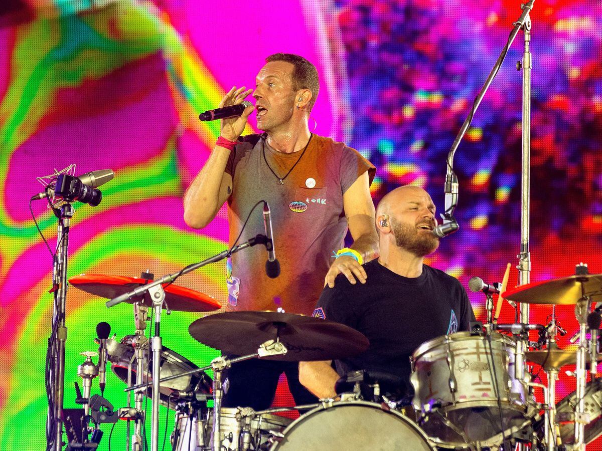 Coldplay’s Chris Martin (left) performing on stage at Wembley Stadium, north London, during their Music of the Spheres tour