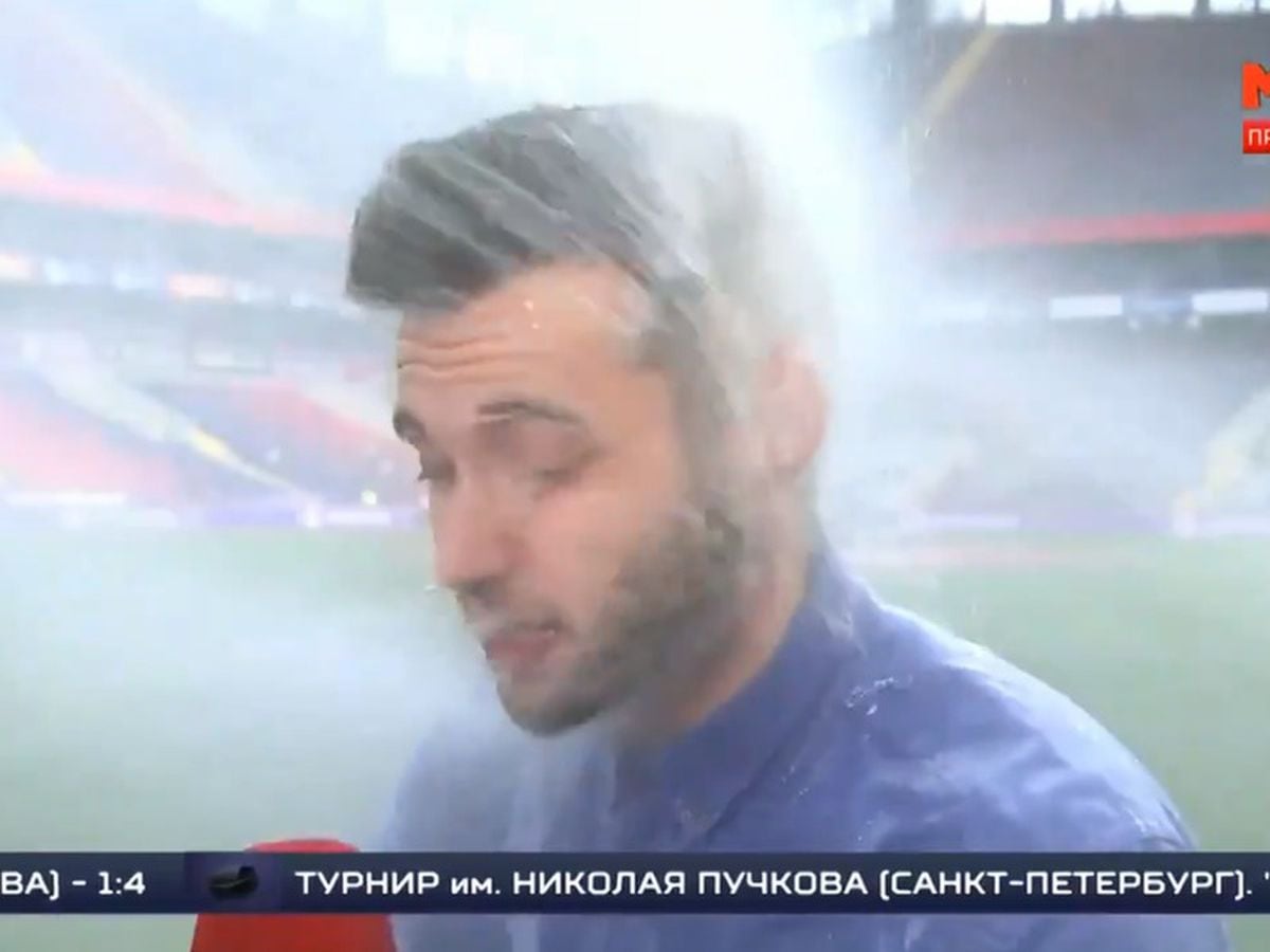 The moment the sprinkler system hit the reporter