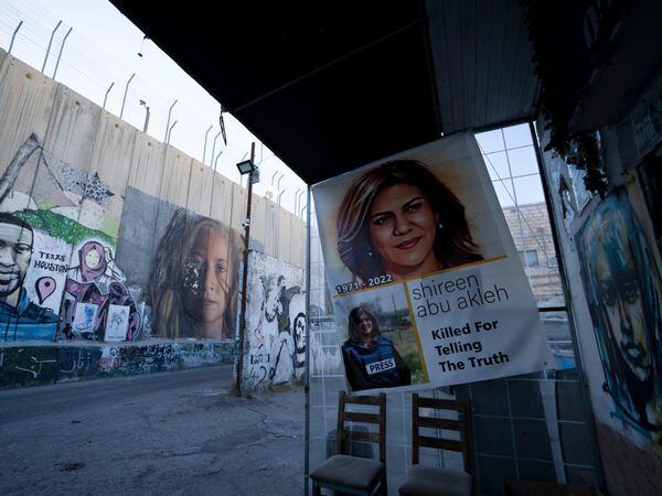 Slain Palestinian-American journalist Shireen Abu Akleh is depicted in a poster near murals of George Floyd, a black American killed by police in Minneapolis in 2020, and Palestinian activist Ahed Tamimi, centre, on Israel’s controversial separation barrier in the West Bank town of Bethlehem