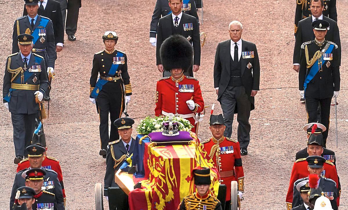 Garrison Sergeant Major Stokes and members of the royal family follow the coffin of Queen Elizabeth II as it was carried on a horse-drawn gun carriage from Buckingham Palace to Westminster Hall
