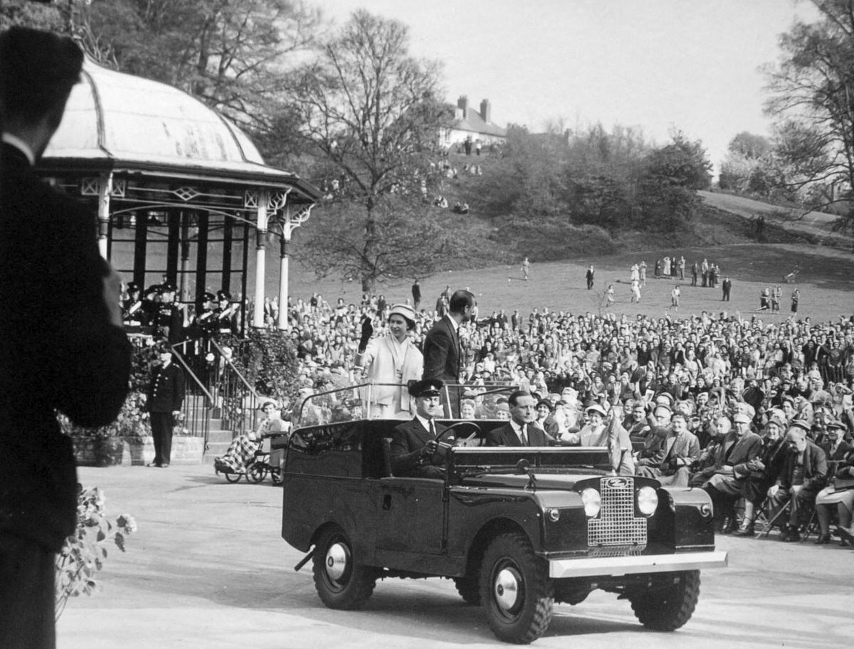 The Queen and Prince Philip riding in an open top Land Rover on a royal visit to Stourbridge in 1957