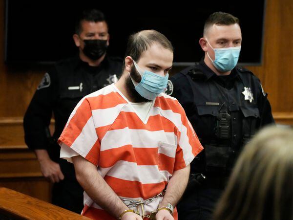 Ahmad Al Aliwi Alissa, accused of killing 10 people at a Colorado supermarket in March 2021, is led into court