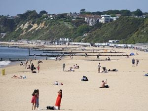 People enjoy the warm weather on Bournemouth beach in Dorset