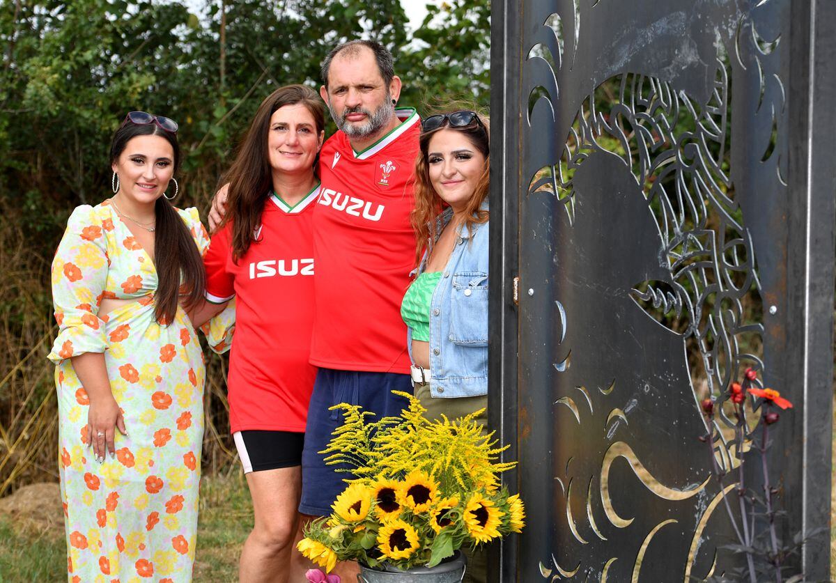 Pictured in the memorial garden which has been created at the club, is Dylan's father Darren, with his partner Sam, and Dylan's sisters Livi and Lizz...