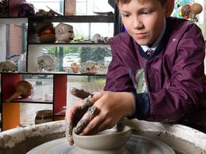 An Old Hall pupil practicing their pottery skills