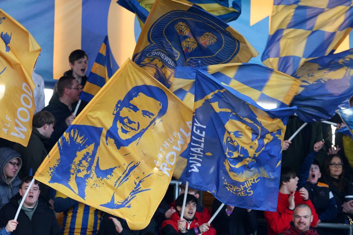 Fans of Shrewsbury Town wave flags of Arthur Rowley and Shaun Whalley.